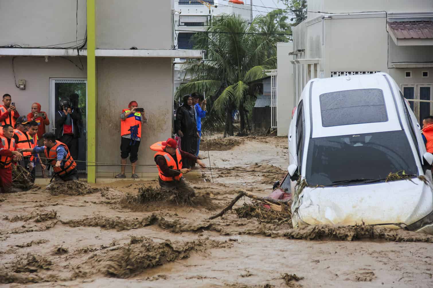 Rescuers wade through flood waters