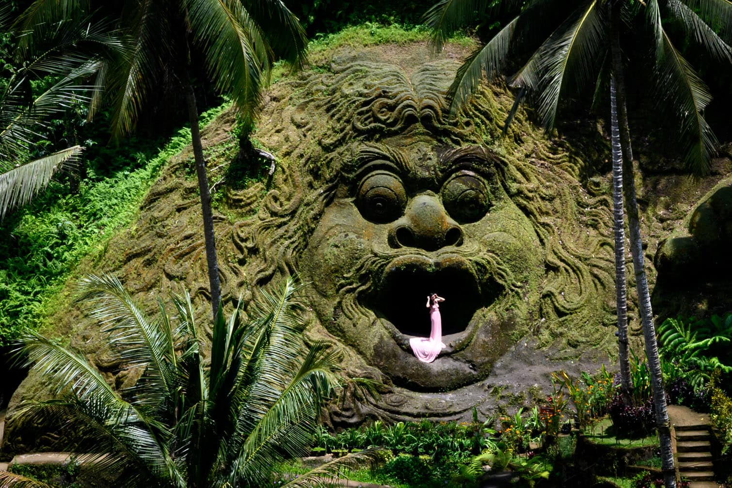 A woman poses for photographs in a sculpture of a giant mythical creature