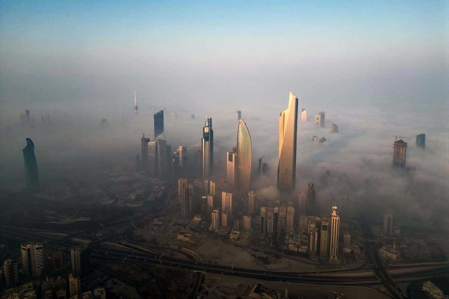 skyscrapers amid morning fog in Kuwait City