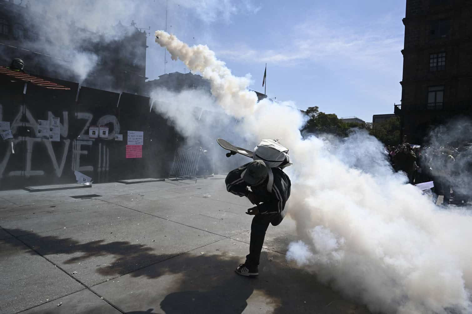A man throws tear gas