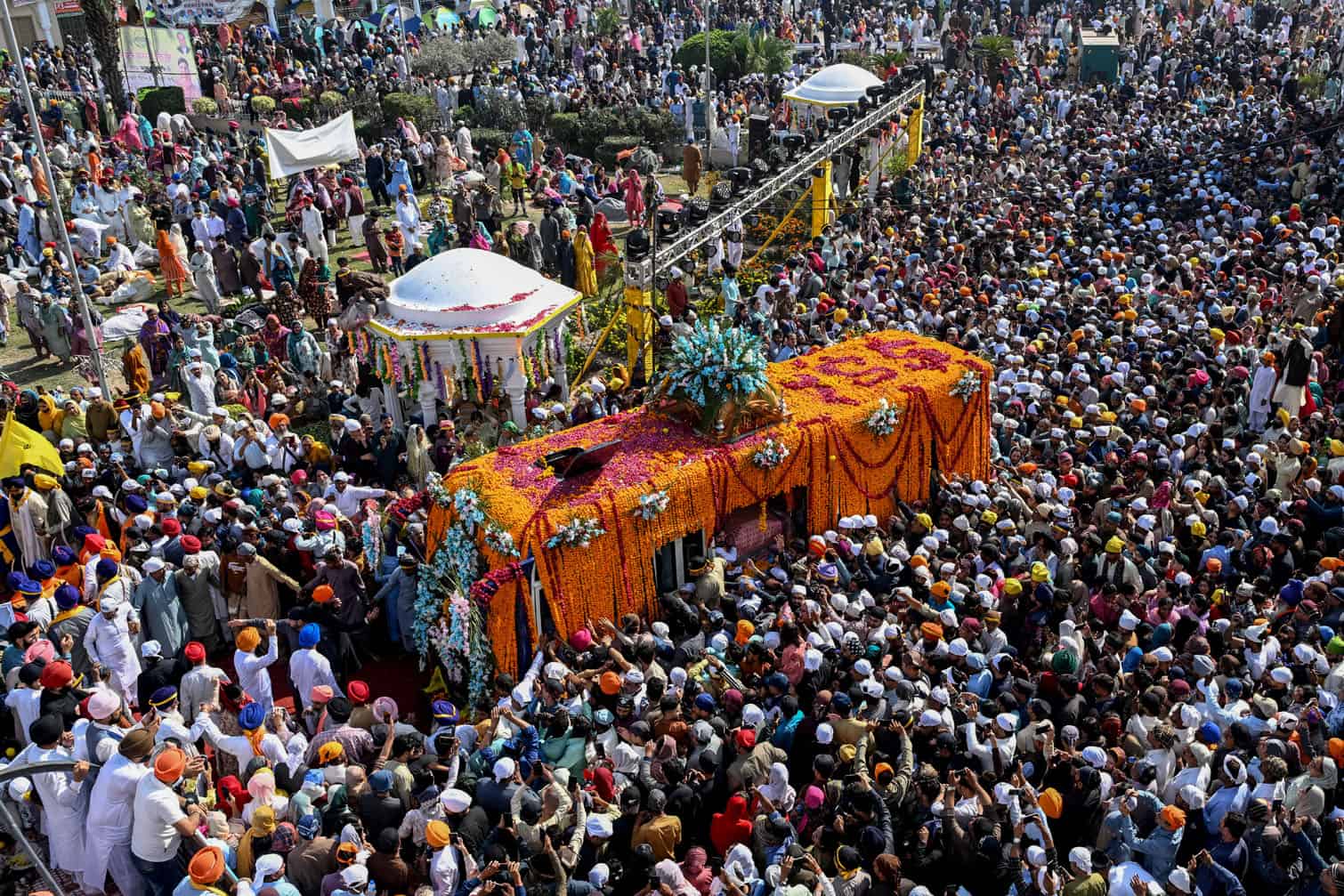 Sikh devotees gather around a bus