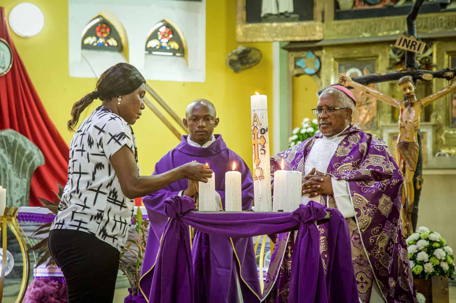 A Catholic lights a candle