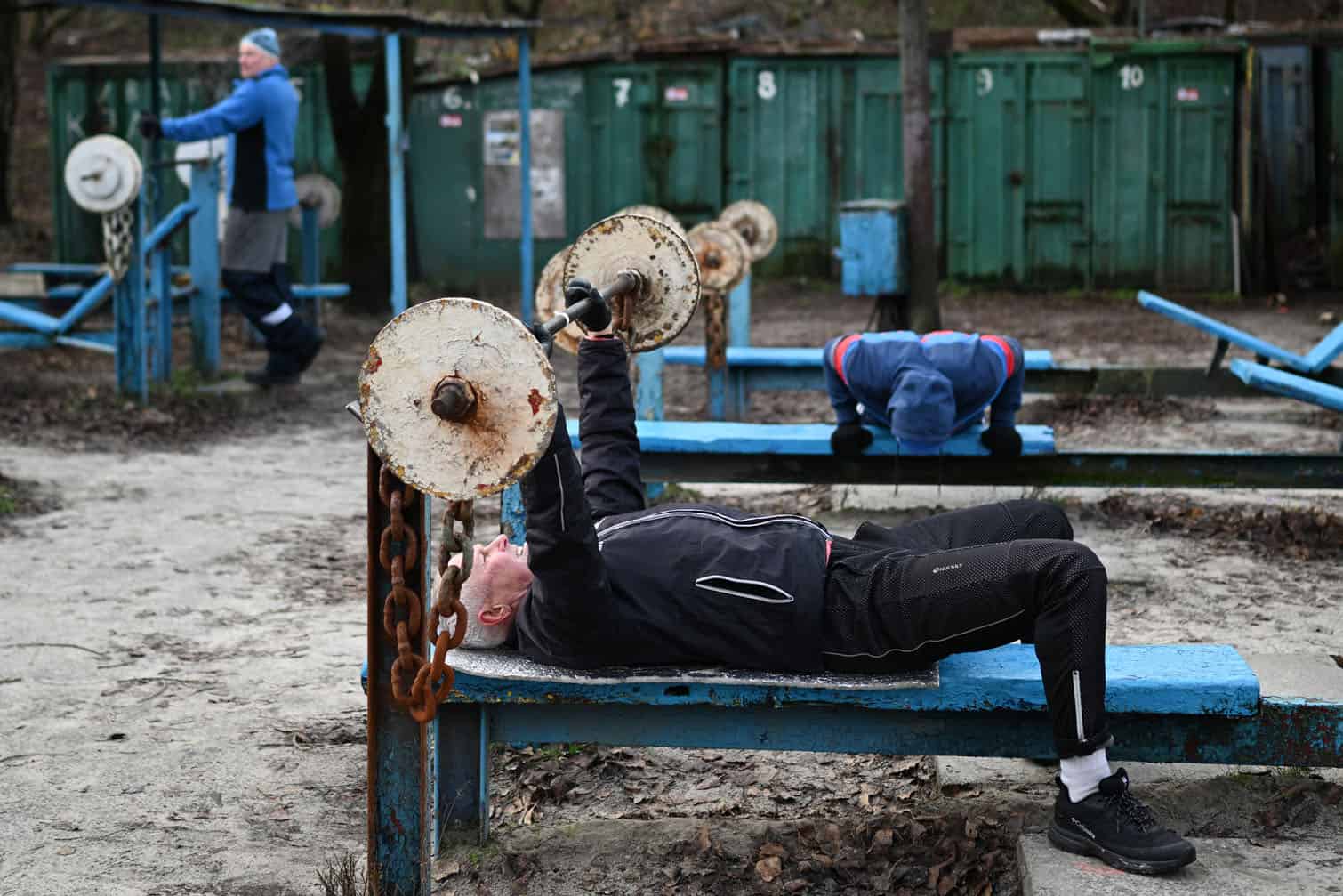 Men excercise at an outdoor gym