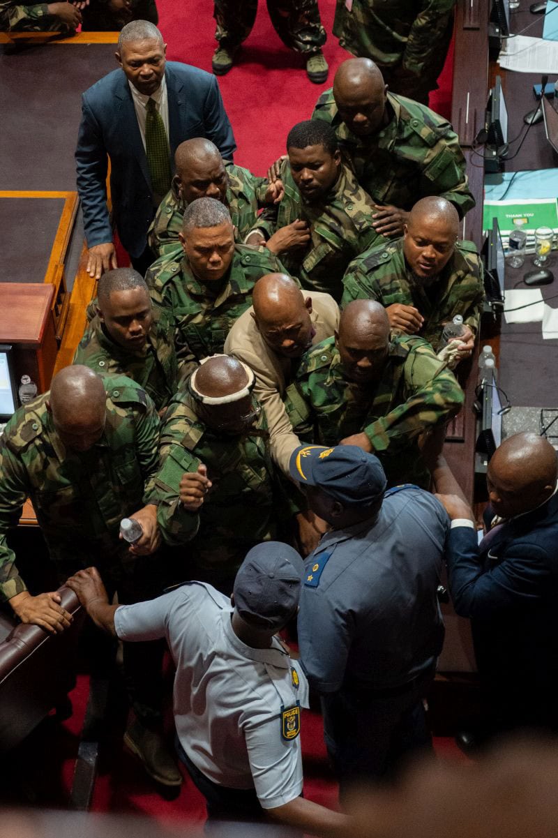 MK party members tussle with police during the motion of no confidence proceedings against KZN Premier Thami Ntuli on 15 December 2025 in Pietermaritzburg. Picture: Gallo Images/Darren Stewart
