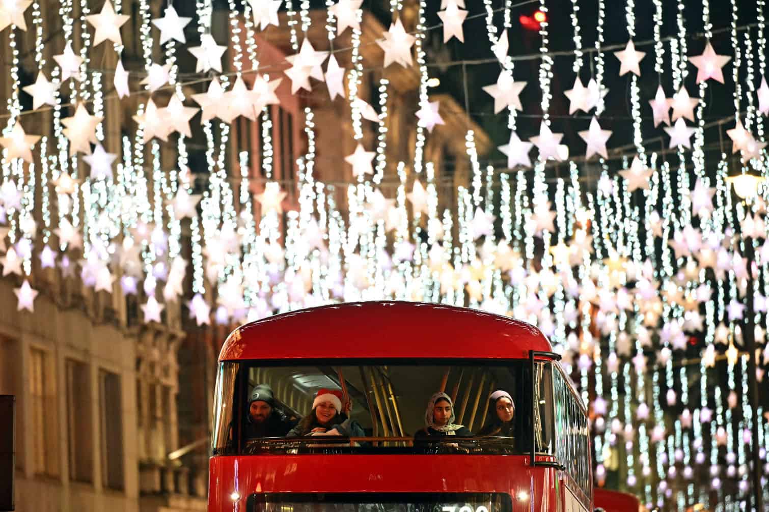 People on a London bus look at the annual Christmas lights on Oxford Street