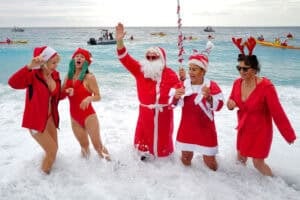 Bathers dressed as Santa Claus and Mrs Claus