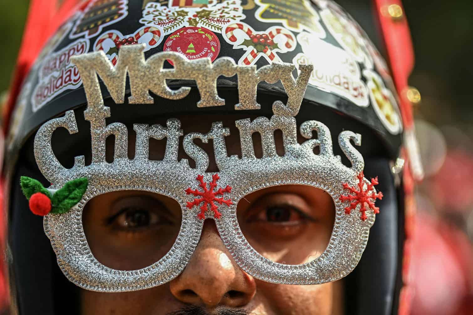 A motorcyclist dressed as Santa Claus