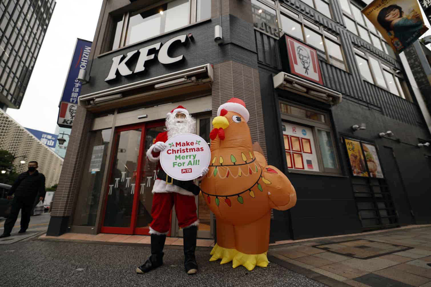 PETA animal rights activists protest outside KFC restaurant