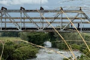 Emergency groups suggested that one or more individuals may have been swept away by the bridge.