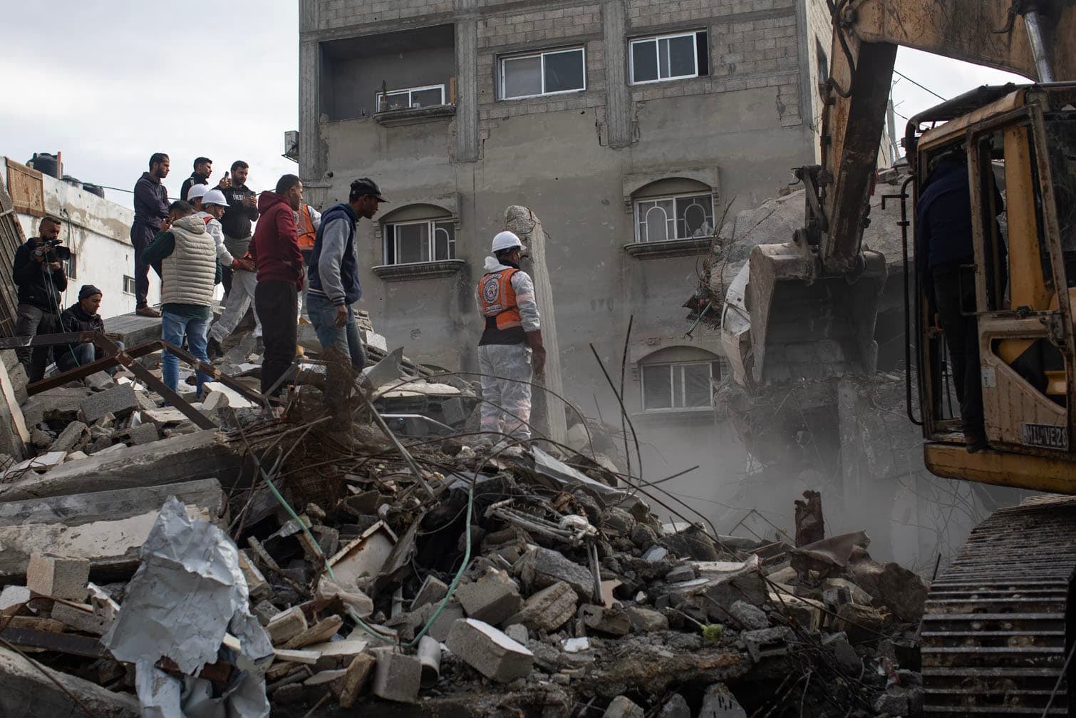 Palestinian Civil Defense teams search for bodies beneath the rubble in Gaza