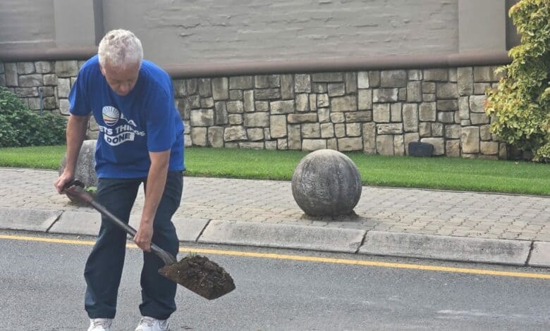 Ward 94 councillor David Foley fills dangerous potholes with sand as a temporary measure.