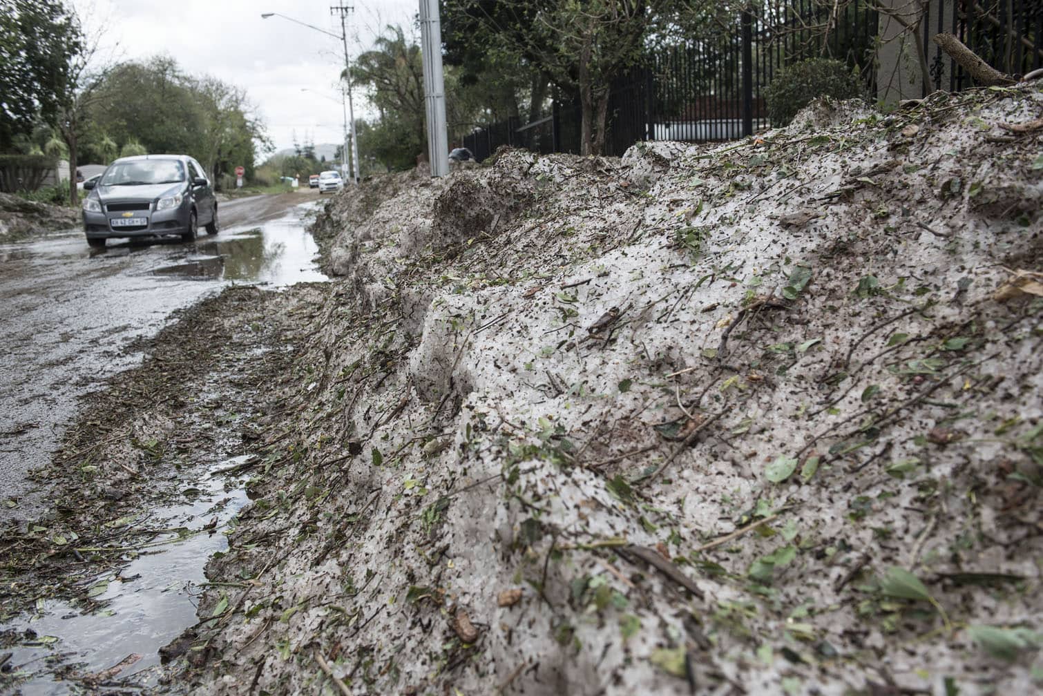 Vehicles navigate through heavy hail