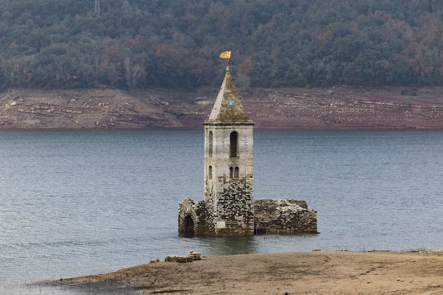 the partially submerged bell tower of the old church of Sant Roma de Sau