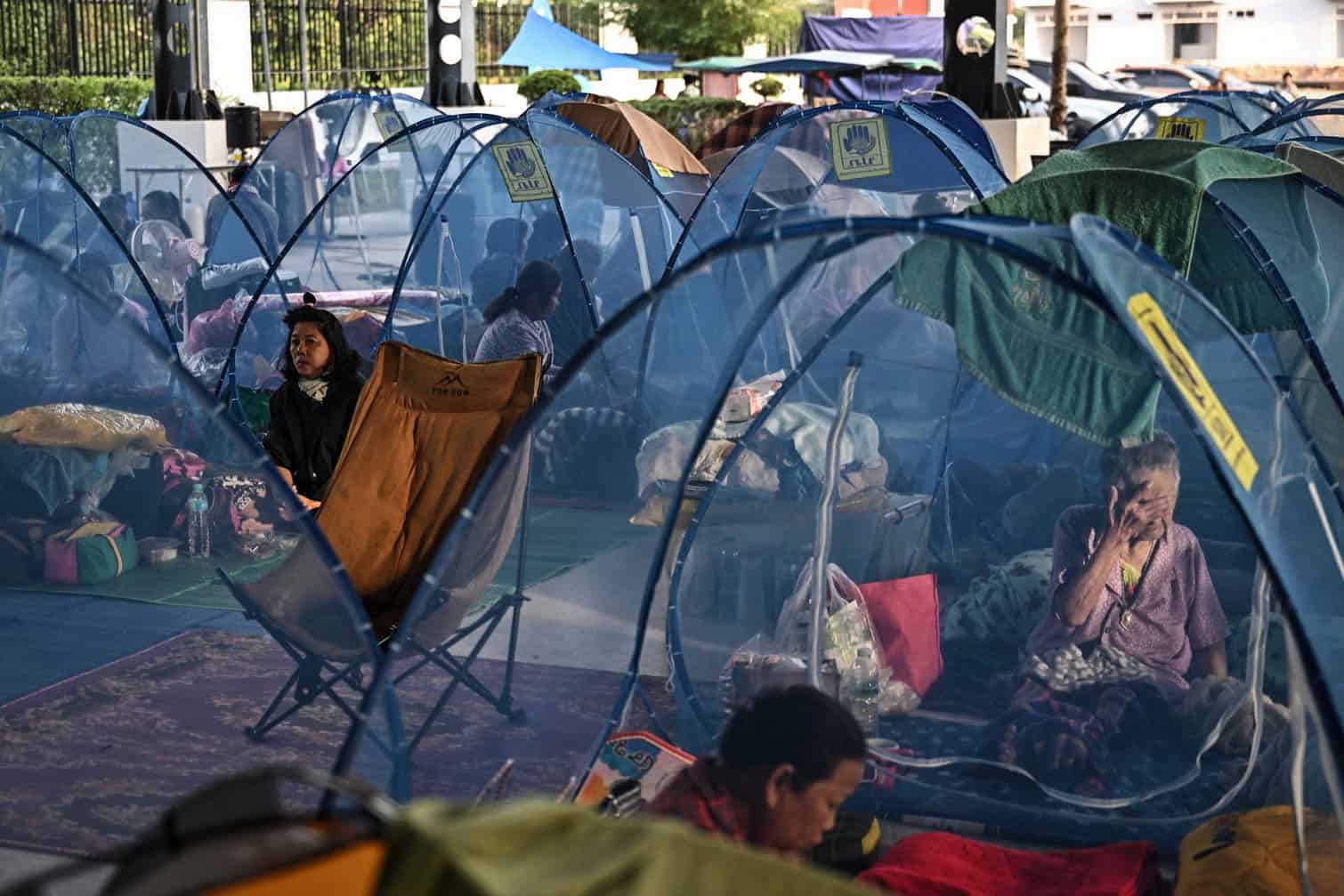 Displaced residents rest as they take shelter at an evacuee center