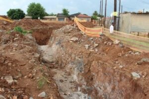 The huge unattended open trench near the old Teachers' Quarters, where a sinkhole caved in last night.