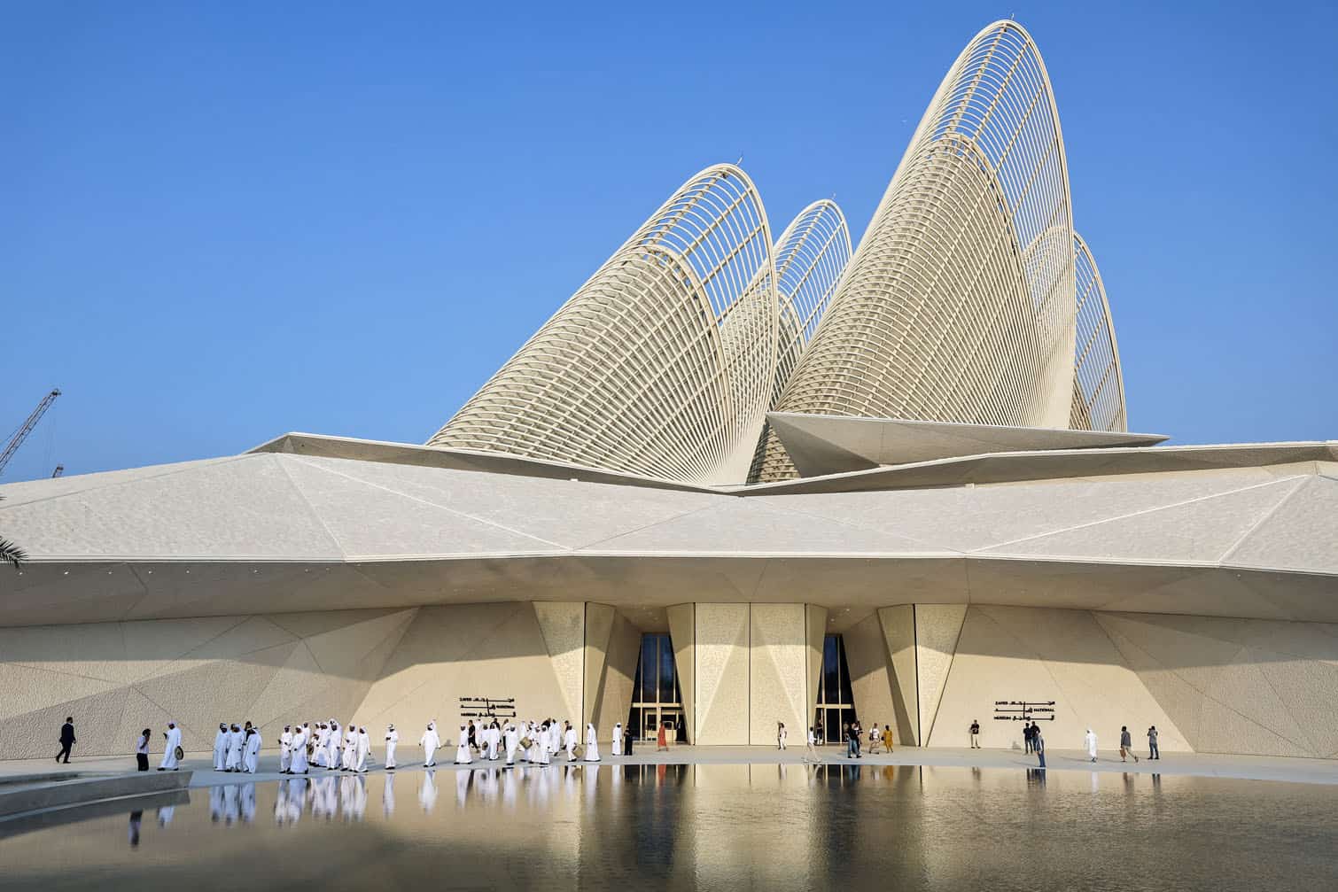 People walk outside the Zayed National Museum