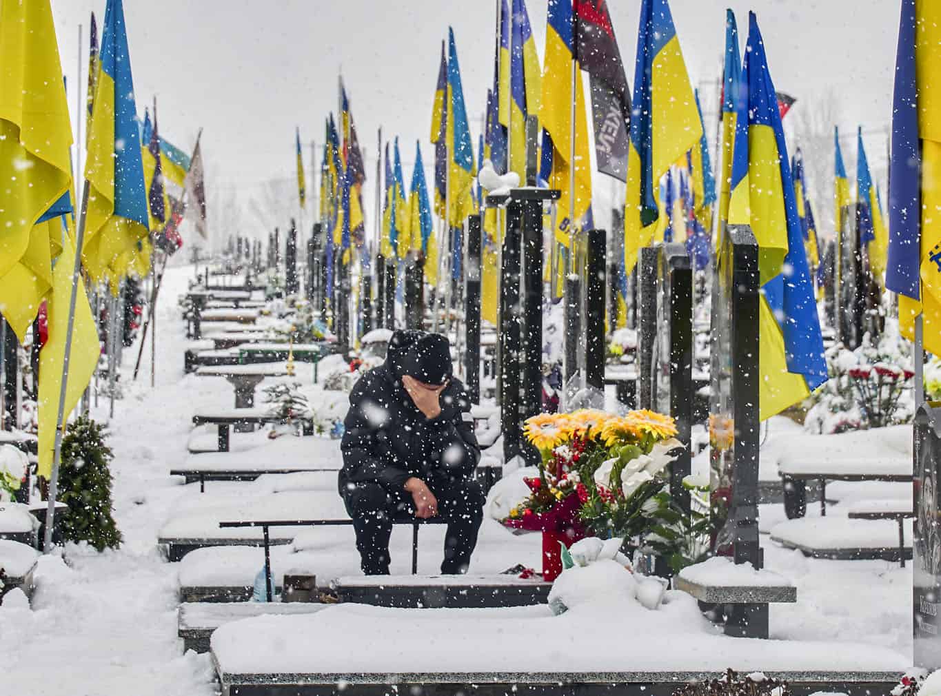 Ukrainians visit a military cemetery in Kharkiv