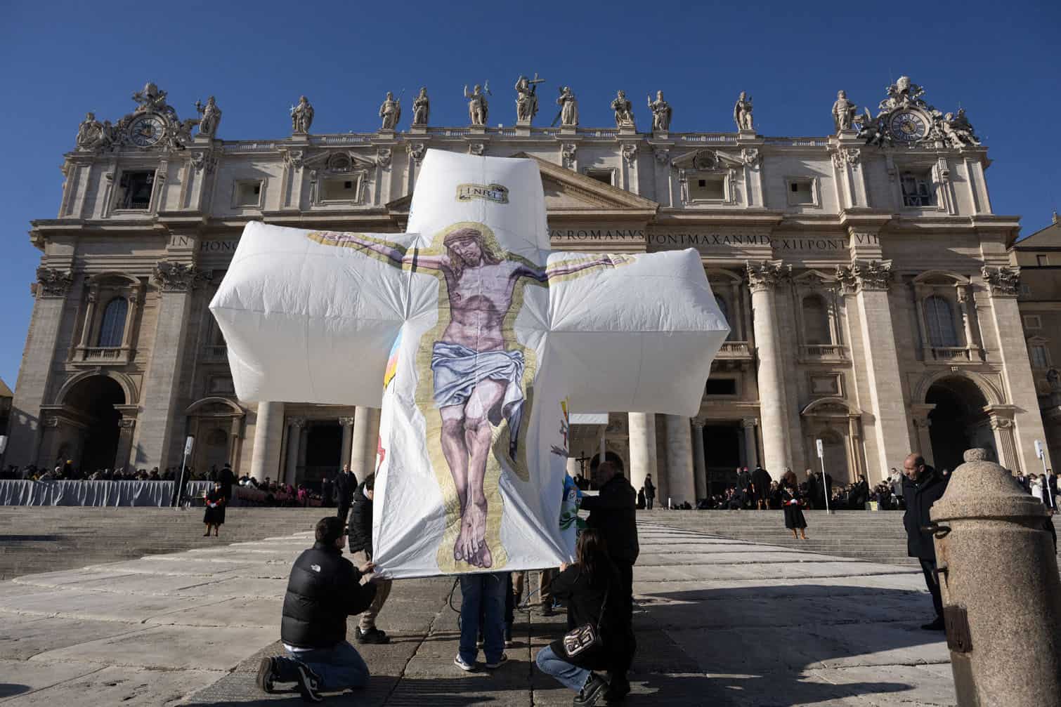 Pilgrims from the island of Ventotene carry an inflatable crucifix