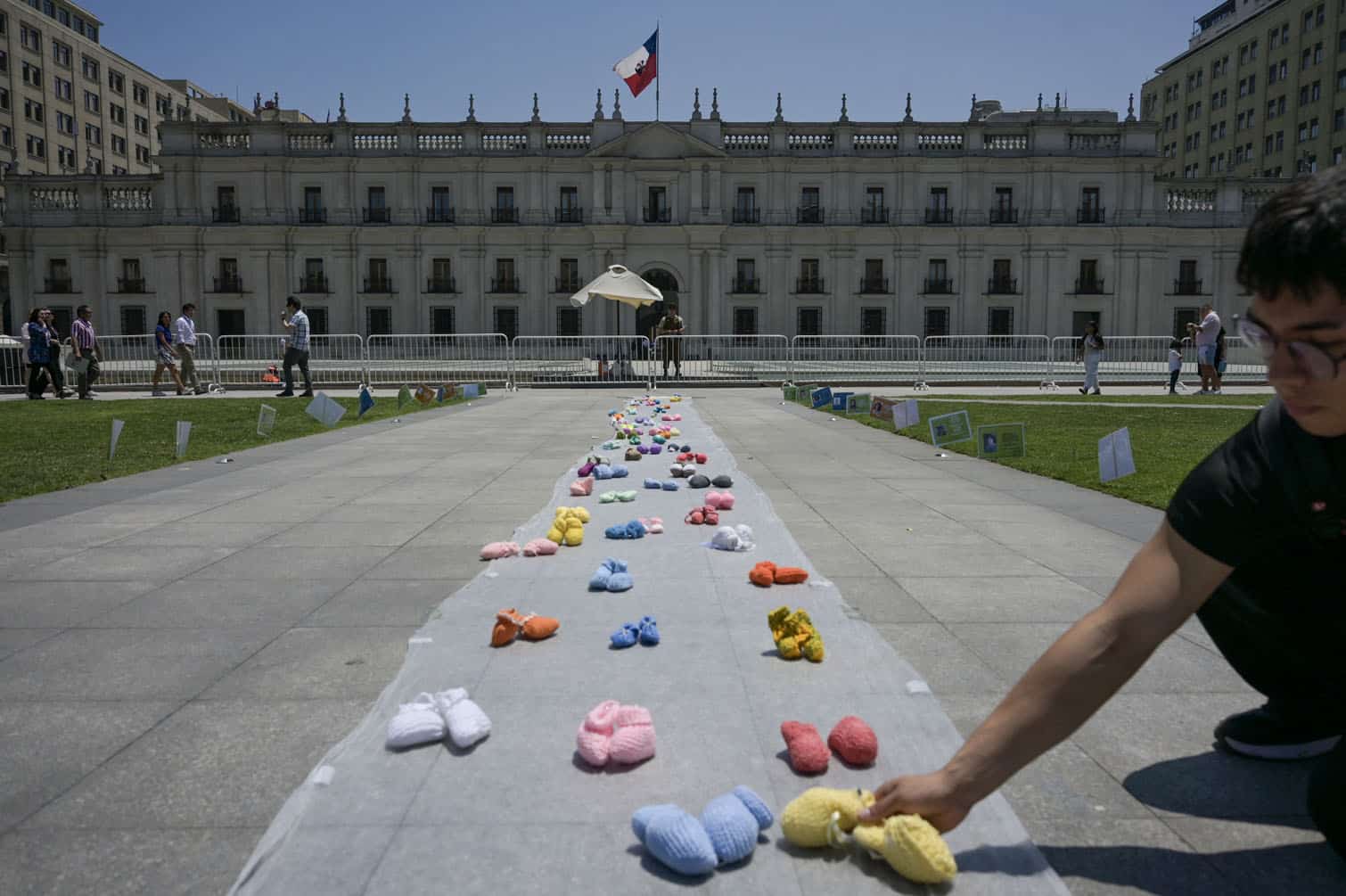 A man arranges baby wool boots