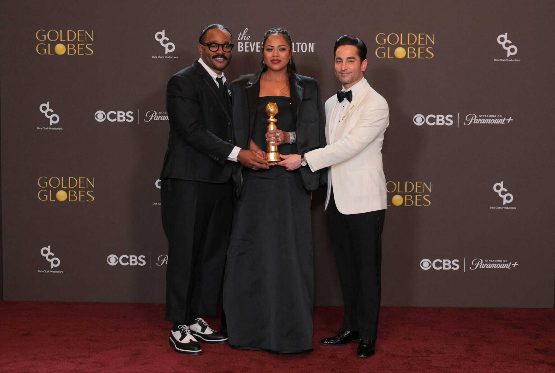 US director Ryan Coogler, US producers Zinzi Evans and Sev Ohanian pose in the press room with the Cinematic and Box Office Achievement award for 