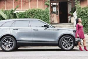 Women standing next to Range Rover Velar