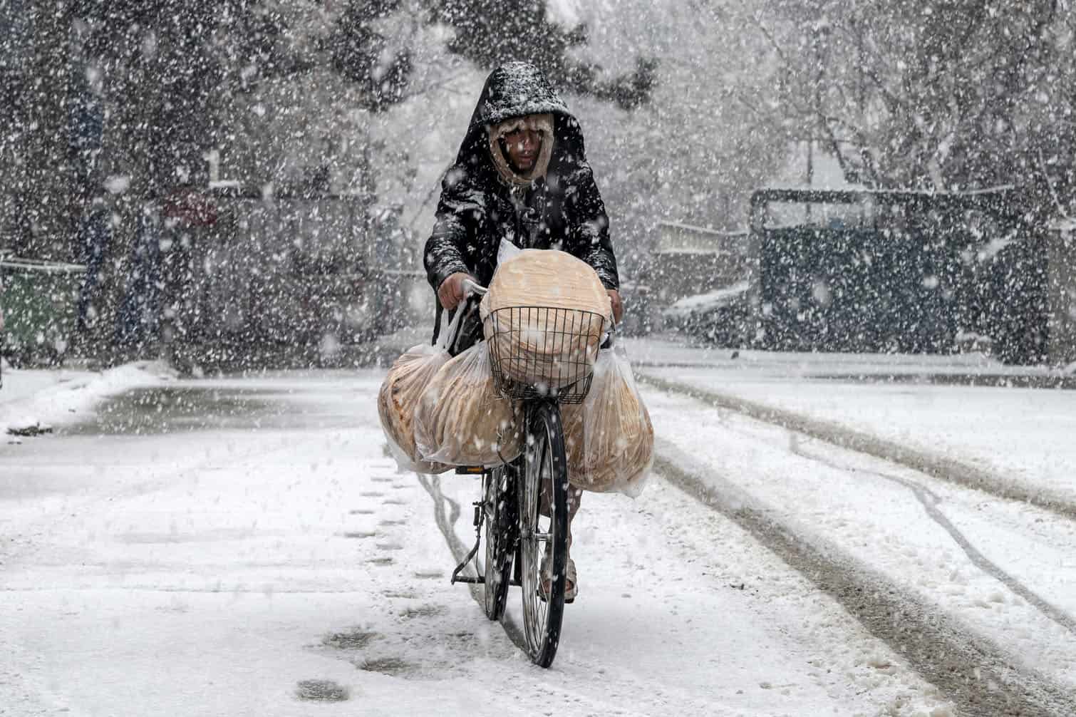 An Afghan man rides a bicycle