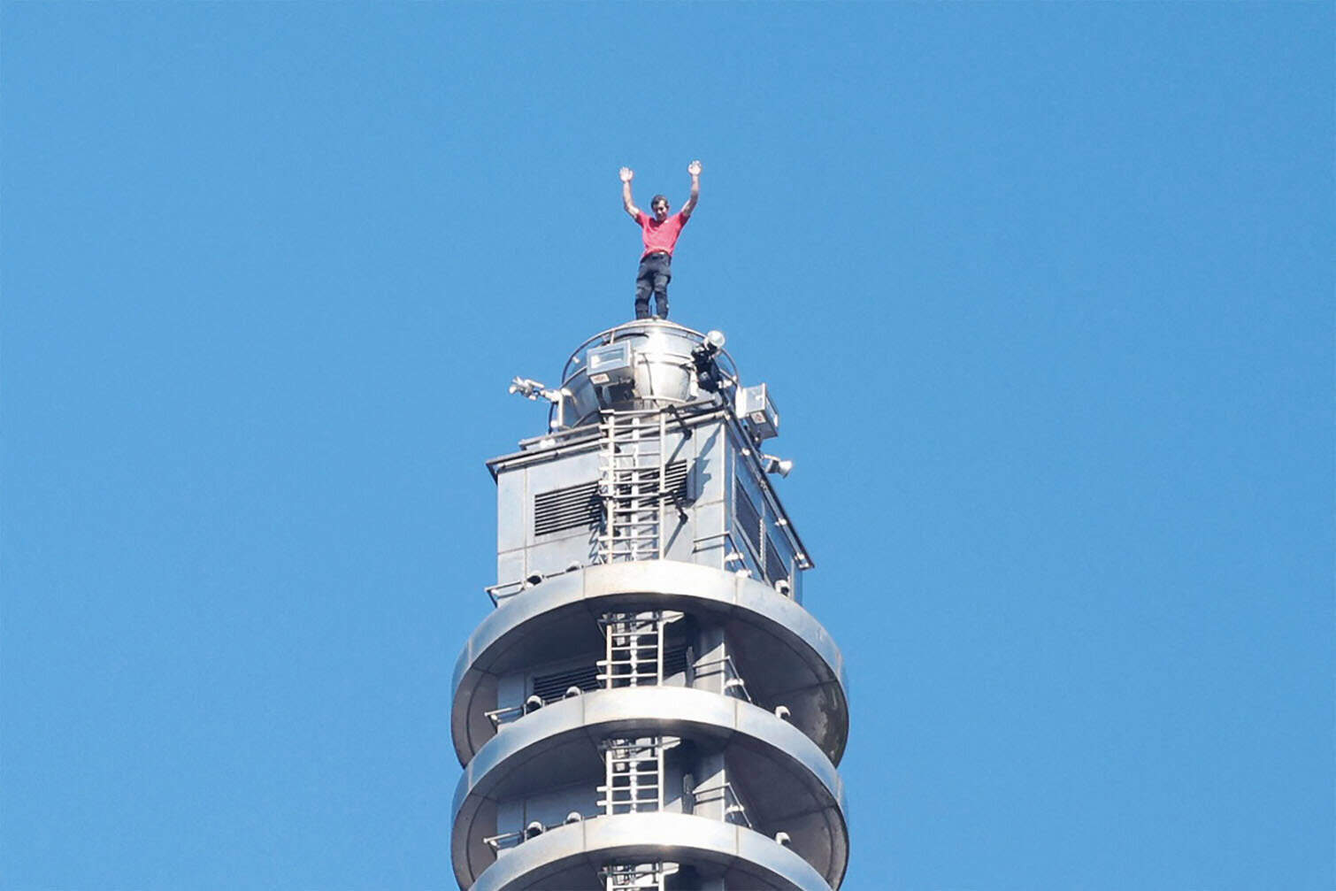 US rock climber Alex Honnold raises his arms from the top of the Taipei 101