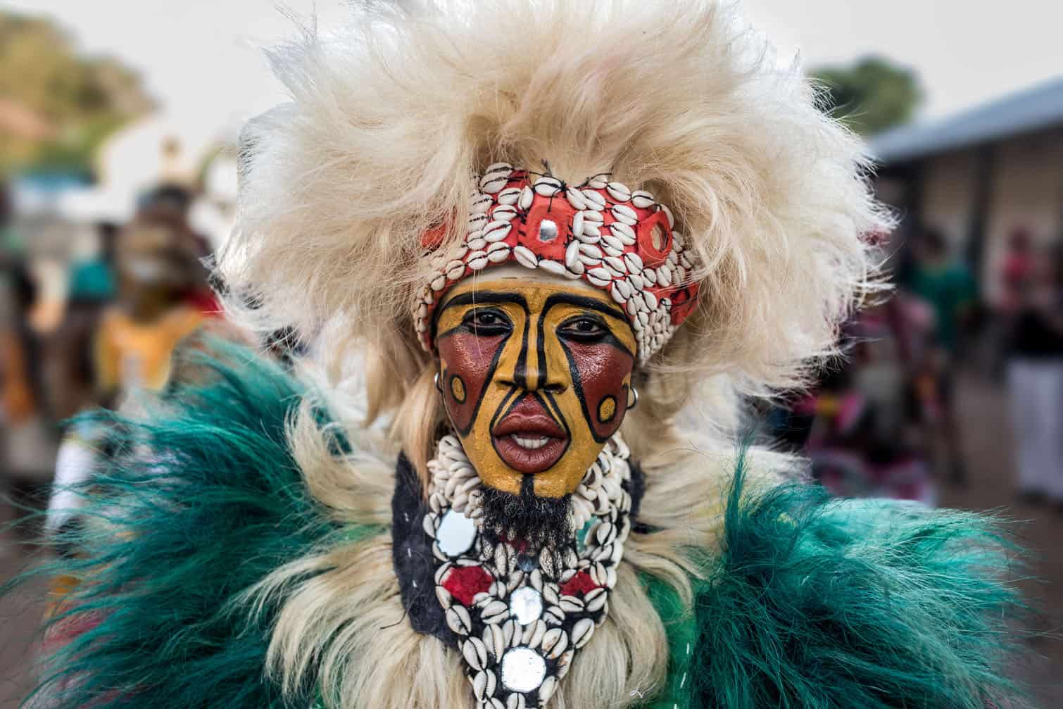A man wearing traditional simba mask