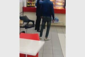 In the video, a security guard is seen protecting the man from an angry mob who wanted to teach him a lesson following the alleged assault on his mother.