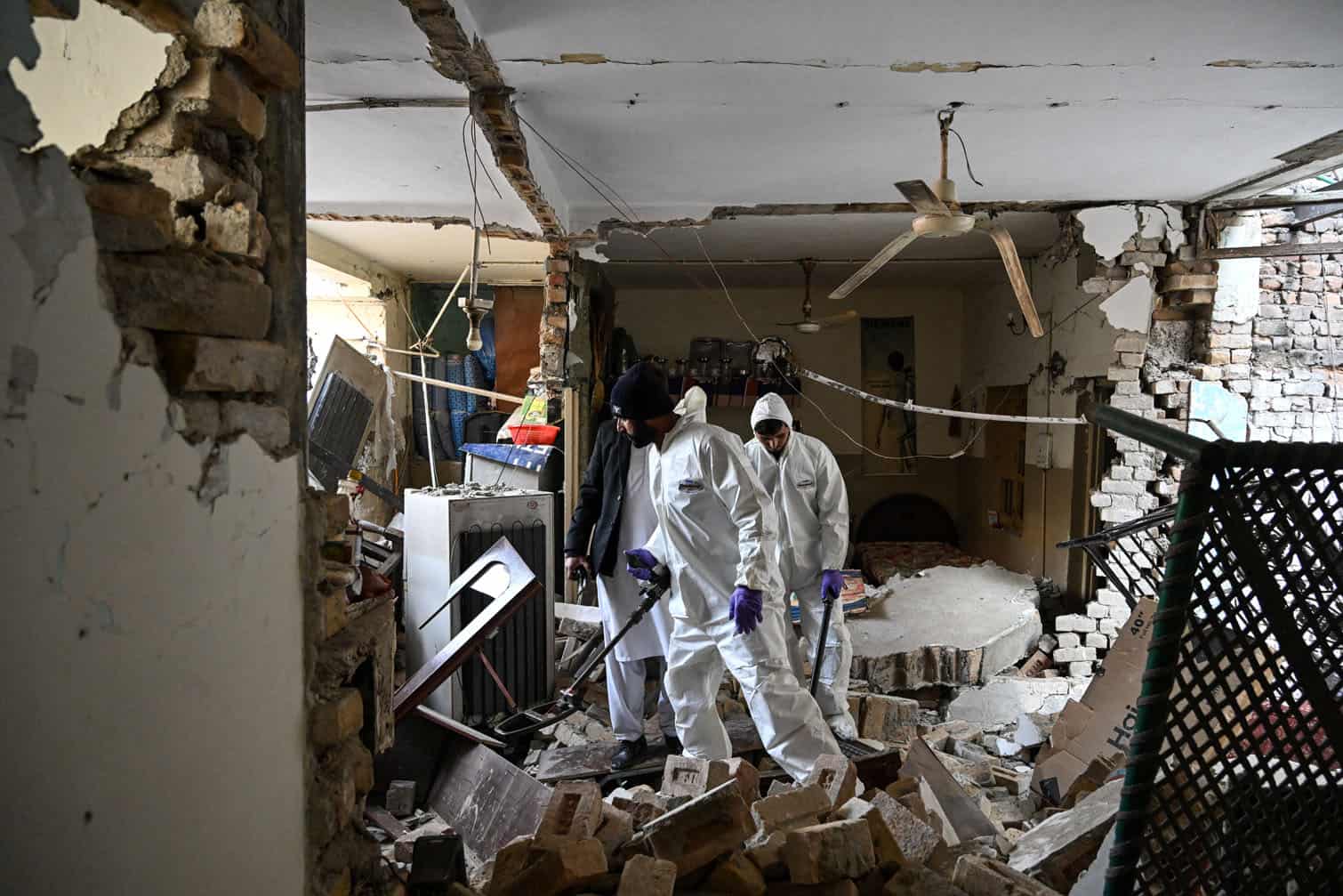 Forensic officials use metal detectors