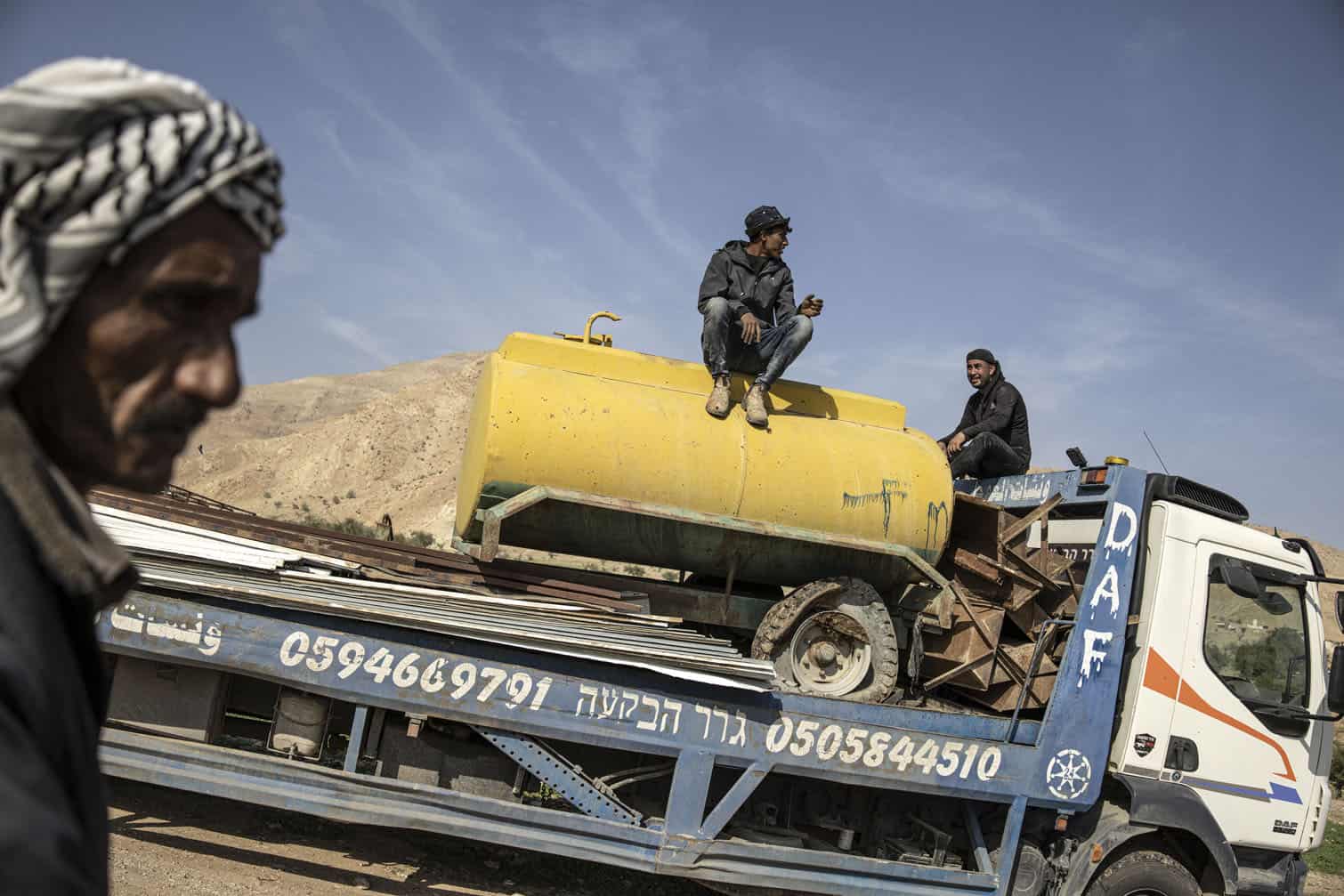 A man sits on a water tank