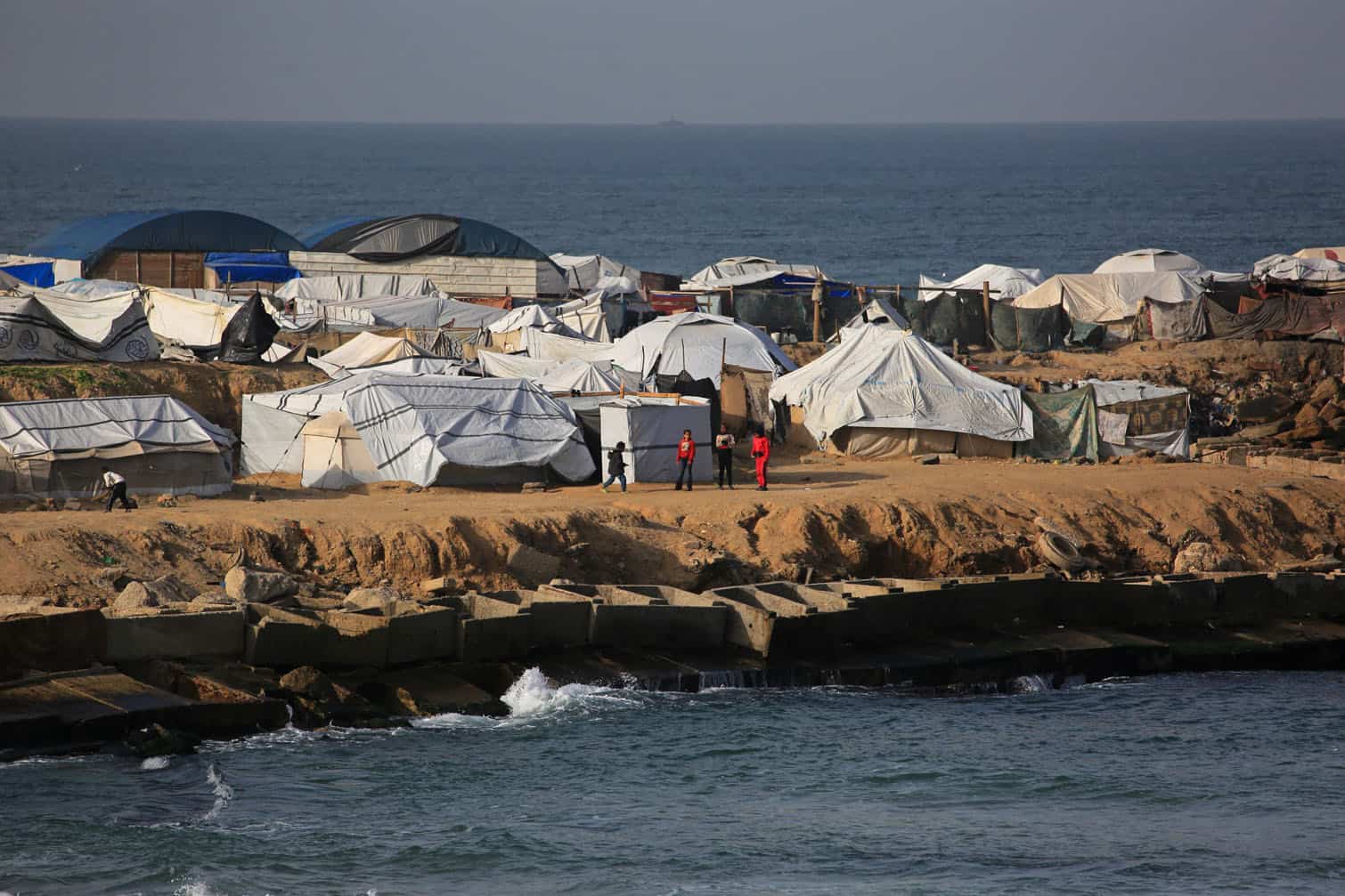 Children play next to the tents