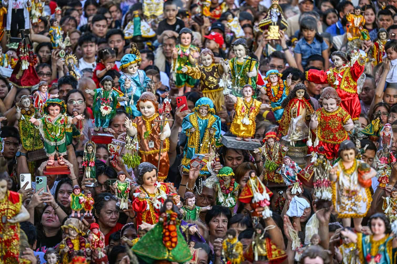People carry religious icons of Baby Jesus