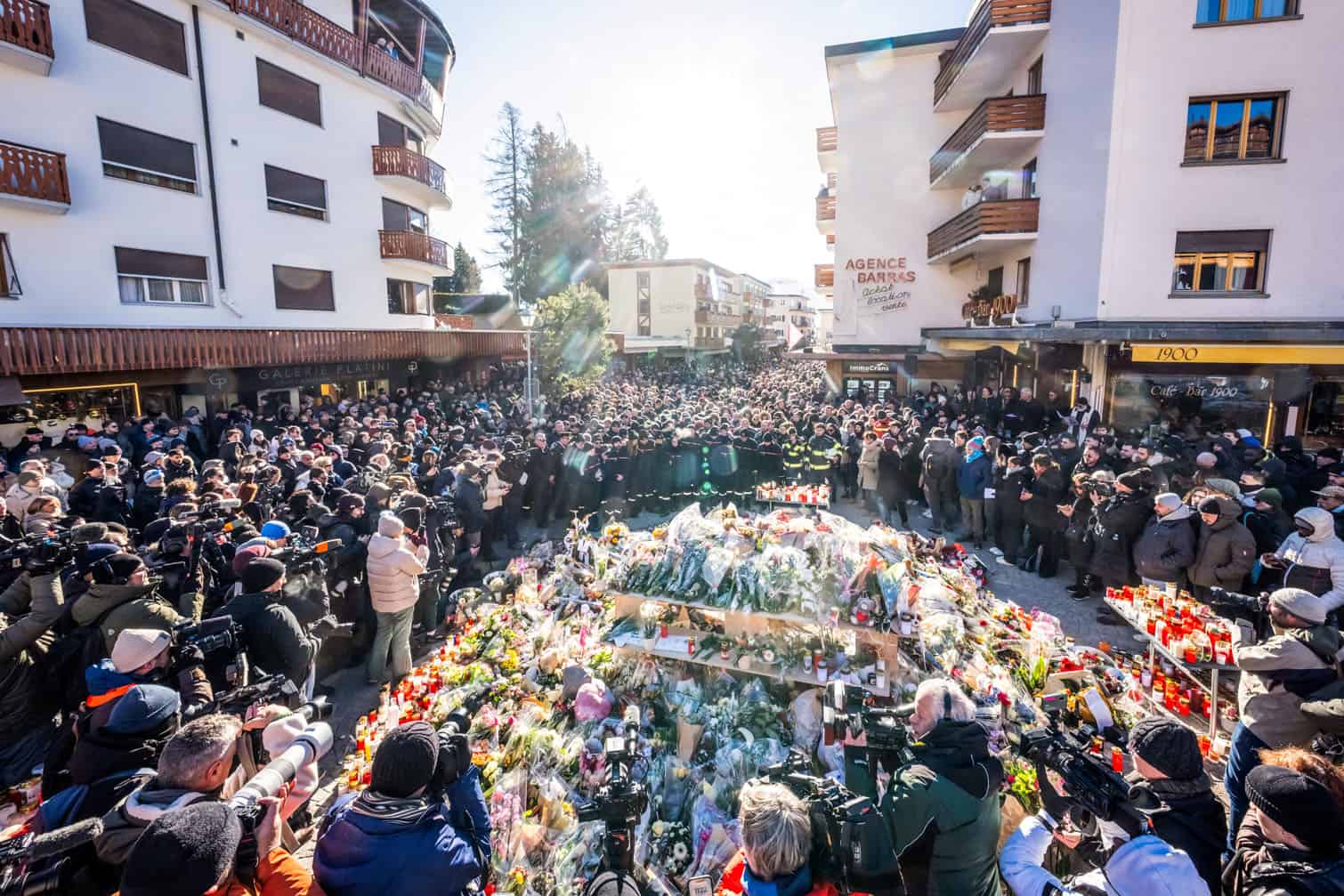 People gather around a makeshift memorial