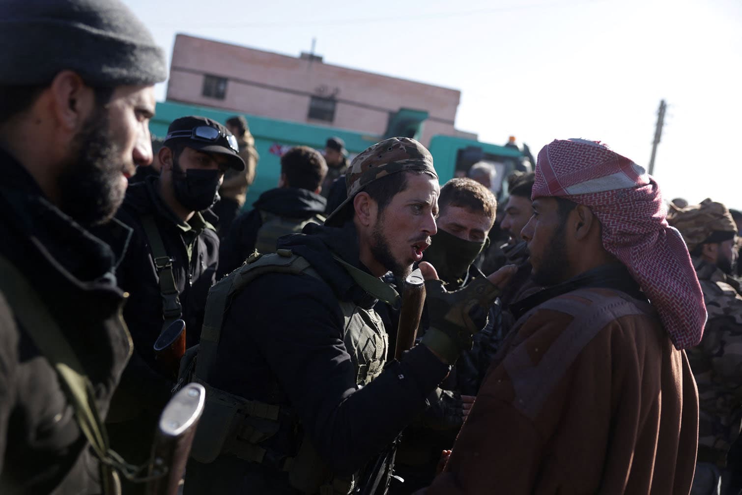 Syrian security forces speaks to a man