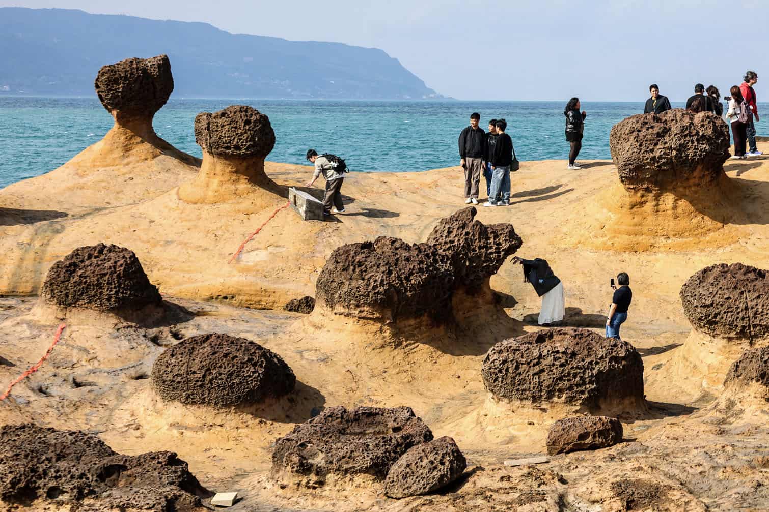 Tourists take pictures at the Yehliu Geopark