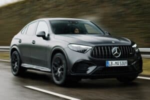 Benz EQB electric SUV driving on a road, showcasing modern design and performance.