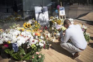 Man kneeling down at a memorial