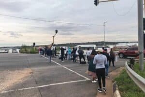 The road is blocked by angry protesters.