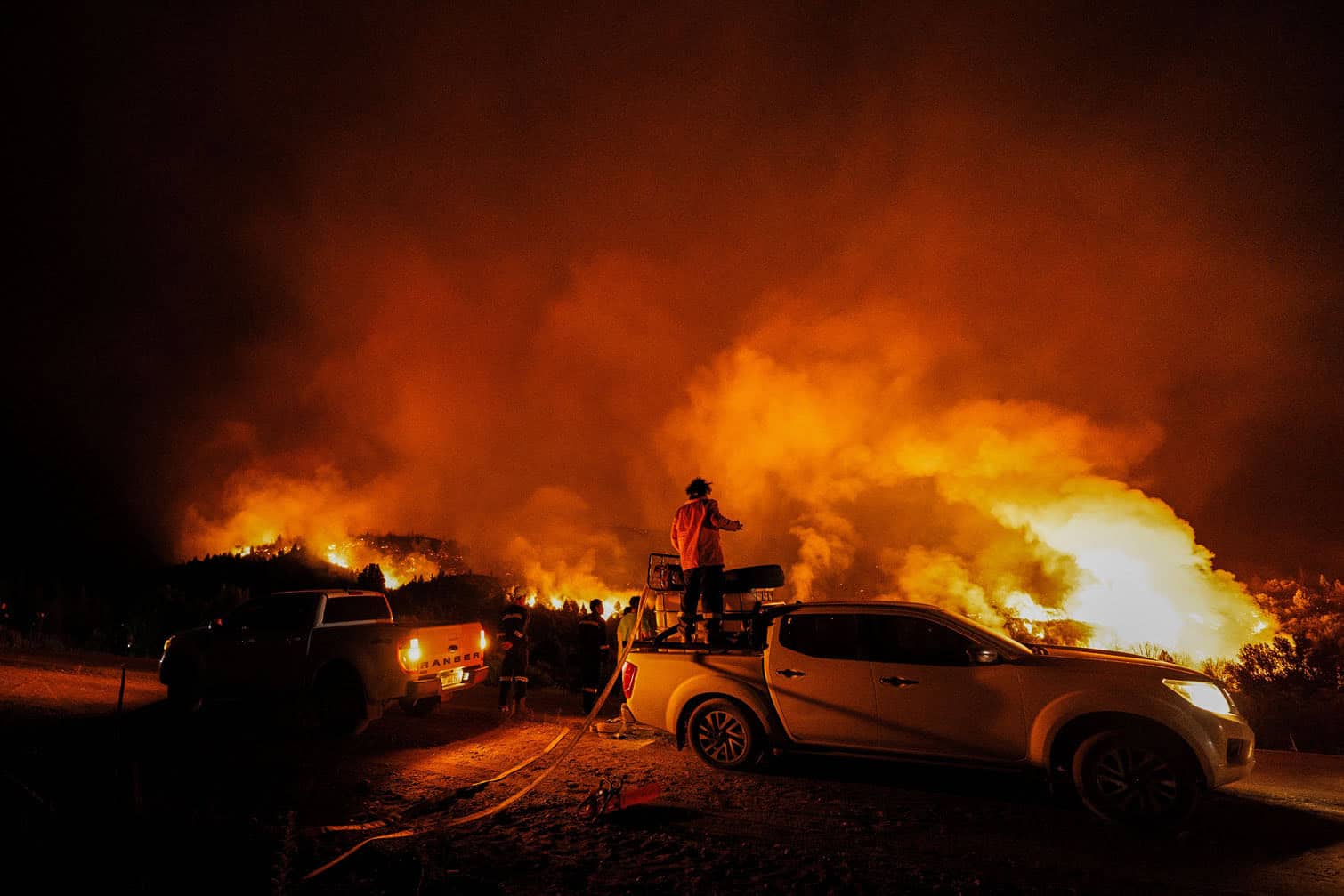 A firefighter works on a vehicle equipped with water pumps