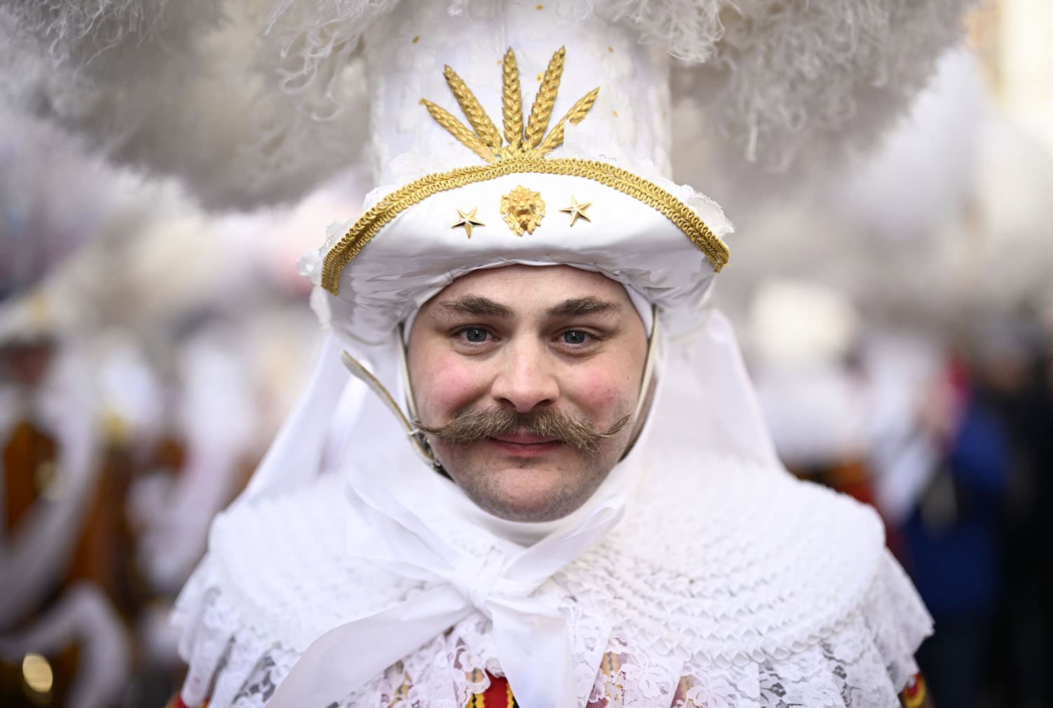 A carnival goer dressed up as Gilles de Binche