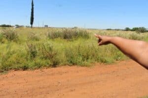 One of the residents, who do not want to be identified because they fear the attackers, shows how the criminals usually come from the direction of the main road to Potchefstroom.