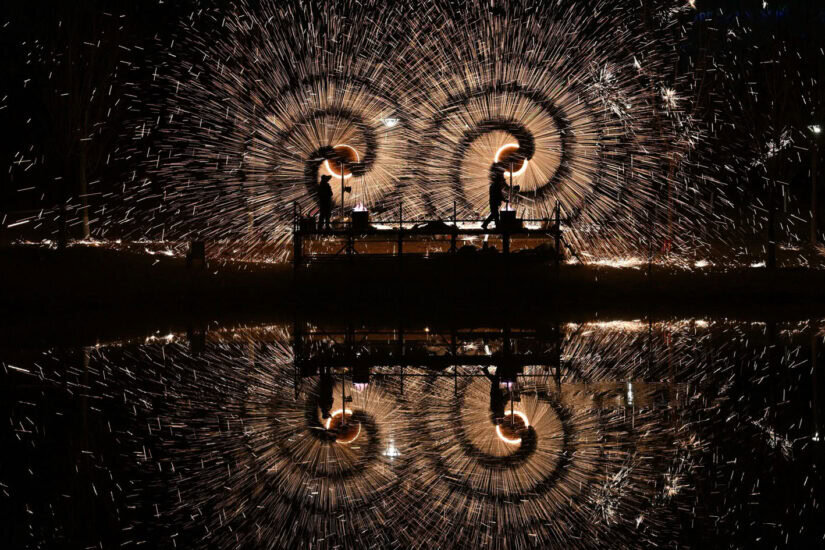 Men perform molten iron fireworks