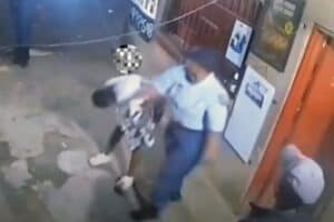 A screen grab from a video widely circulating, showing a female police officer hitting a woman.