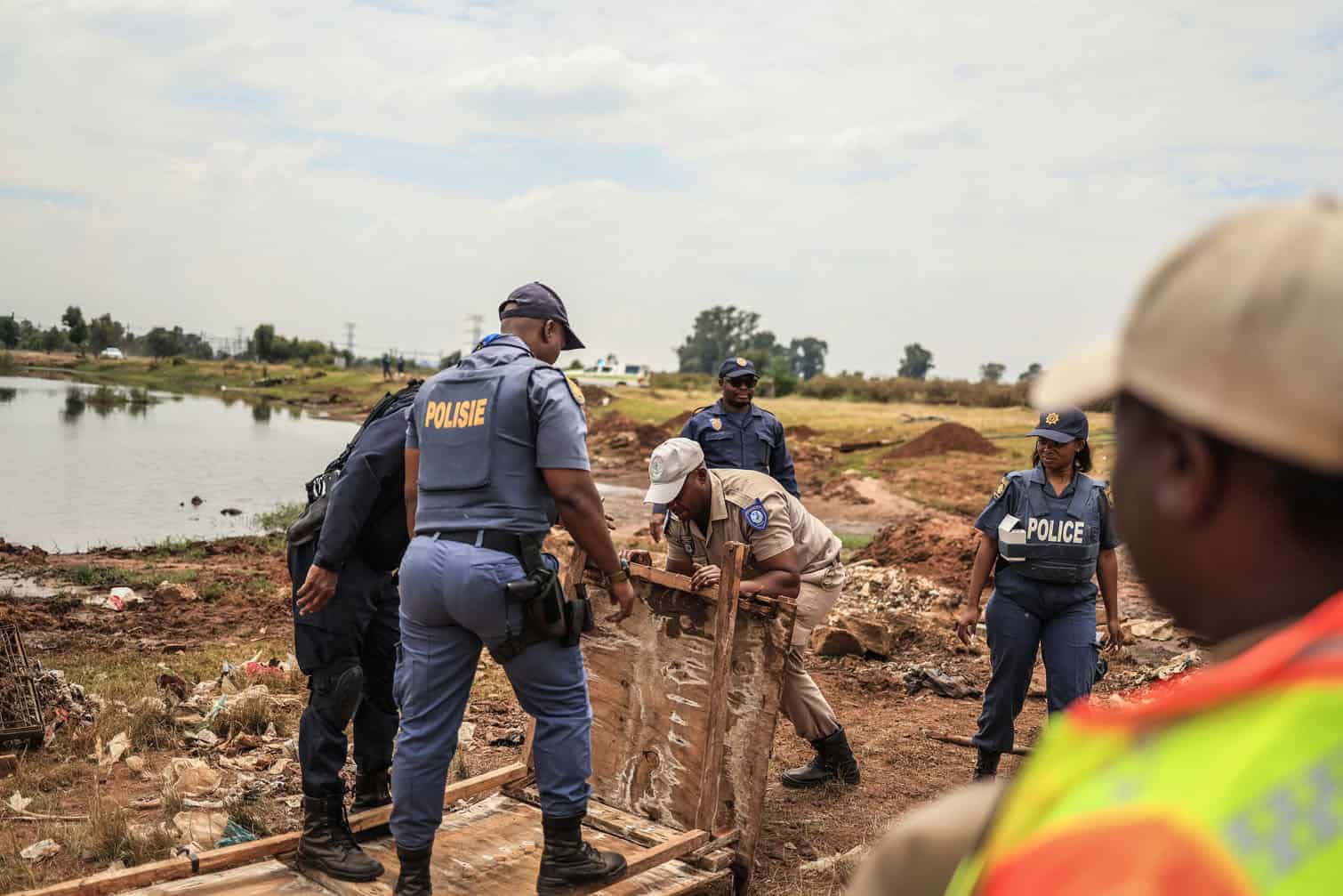 Members of the South African Police Service (SAPS) confiscate material