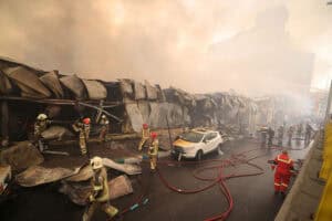 Smoke rises as firefighters battle a fire