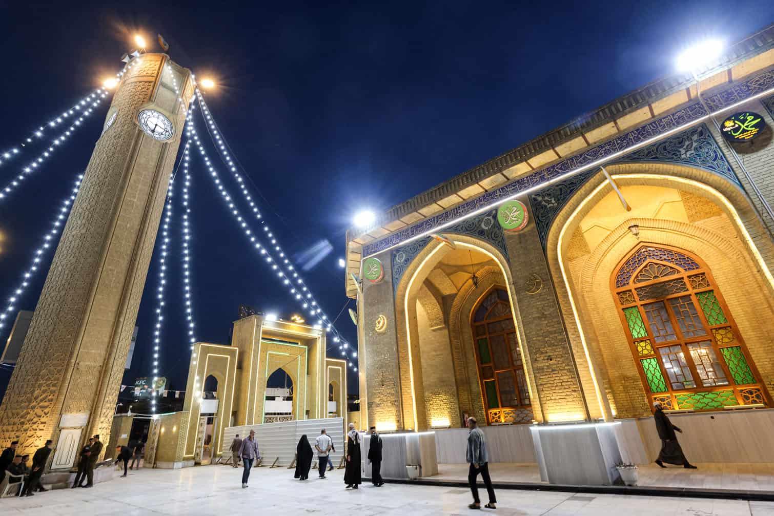 People walk outside the shrine of Sheikh Abu Hanifa al-Numan