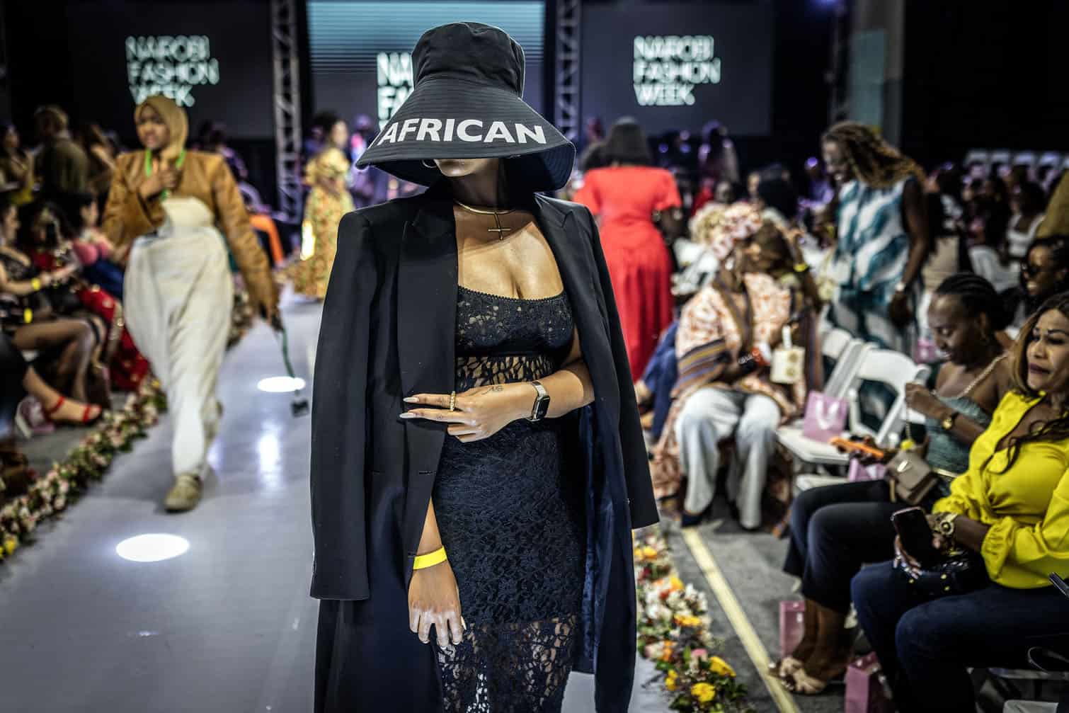 A fashion enthusiast stands by the catwalk