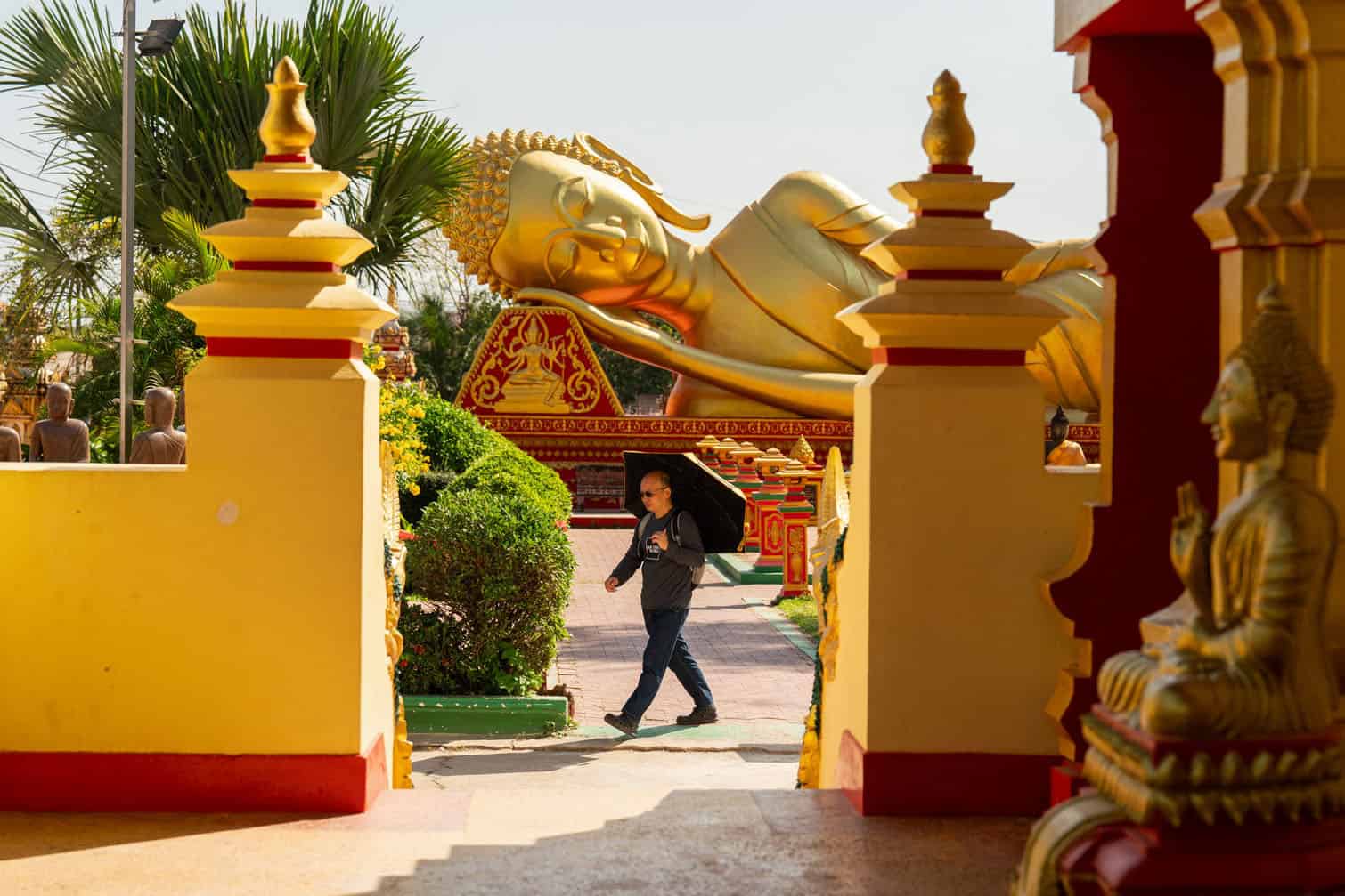 A man walks in the grounds of the Thatluang Stupa in Vientiane