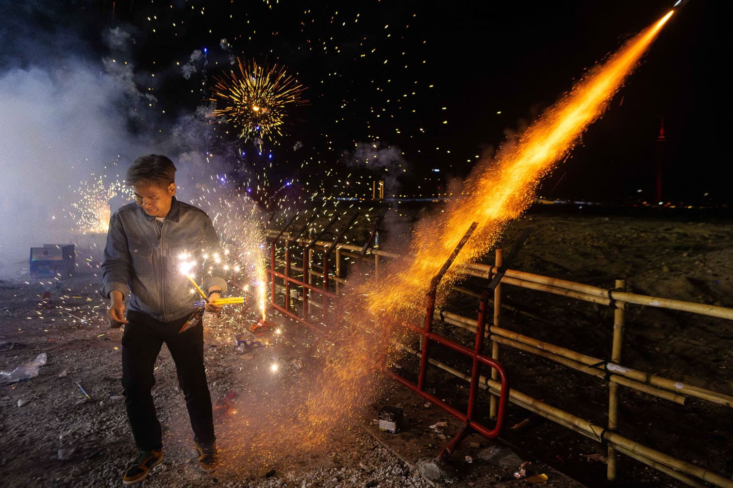 A local resident runs away after setting fireworks